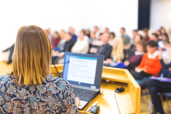 Mid-Career Woman Speaking at a Conference