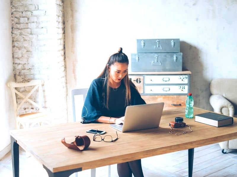 Woman on her lap top at her home desk