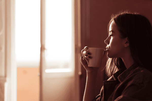 Anxious woman looking out the window