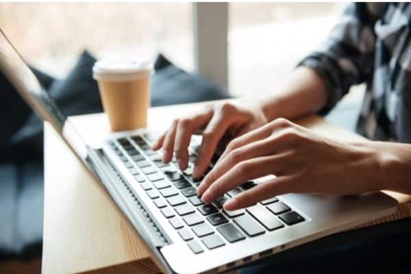 woman typing on a laptop