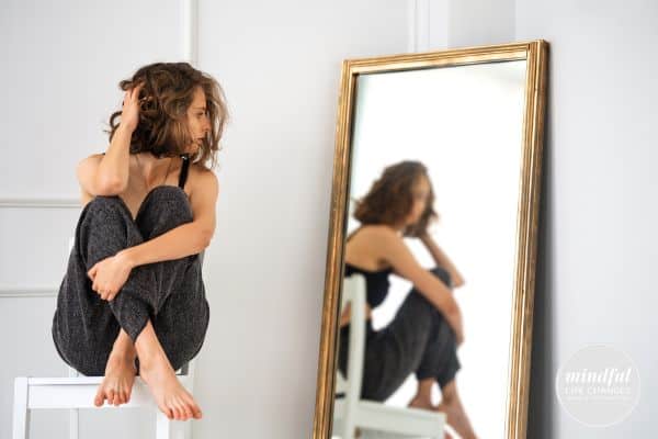 woman looking at herself in the mirror