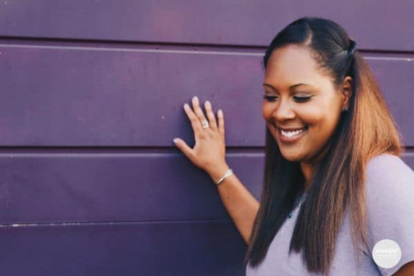 woman smiling, feeling good about trusting her intuition.