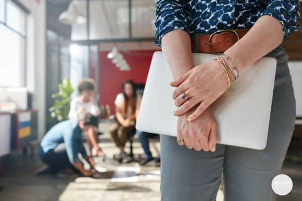 woman in work meeting feeling imposter syndrome