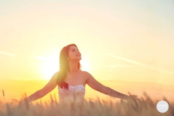 woman in the field, feeling free and full of grace