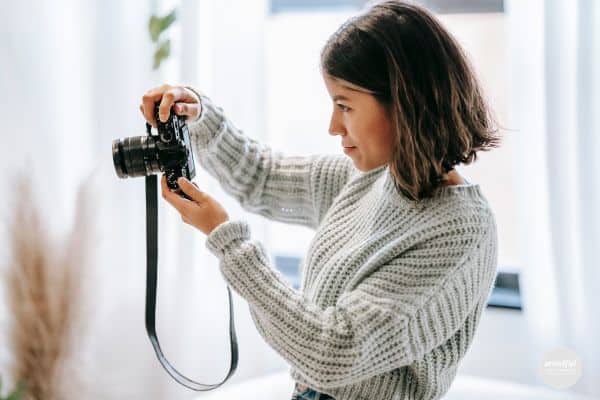 Woman taking a picture, taking action with passion project.