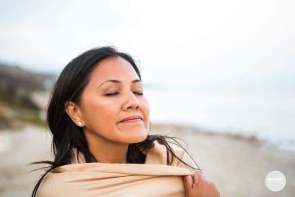 woman practicing stillness at the beach.