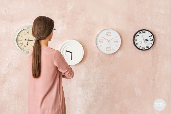 Middle age woman looking at clocks, worried she wasted her time.