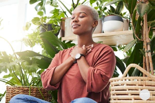 woman practicing basic breathing techniques to help calm and find center.