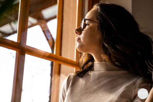 woman looking out the window