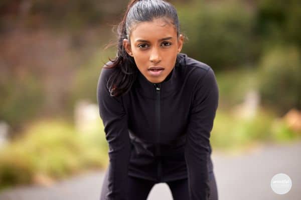 Woman ctaching her breath and digging deep to move forward.