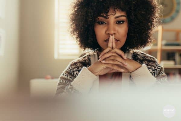 Woman in deep thought, contemplating "I should" statements