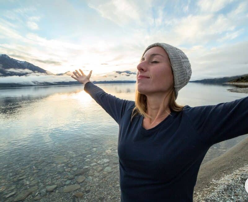 woman feeling empowered embracing the present moment.