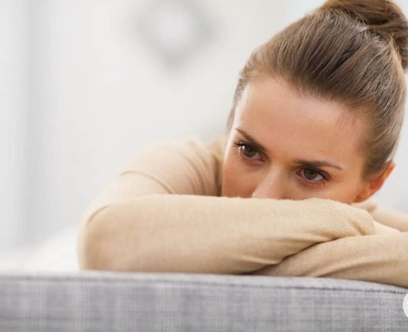 woman looking stressed and feeling guilty for saying no