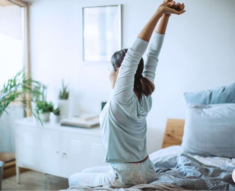 woman waking up energized and starting her day with a morning affirmation