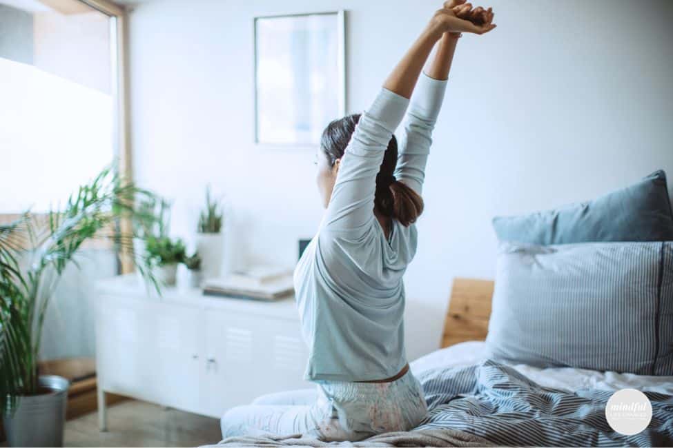 woman waking up energized and starting her day with a morning affirmation